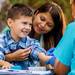 Nurse-examines-little-boy-at-outdoor-free-clinic_Thumbnail